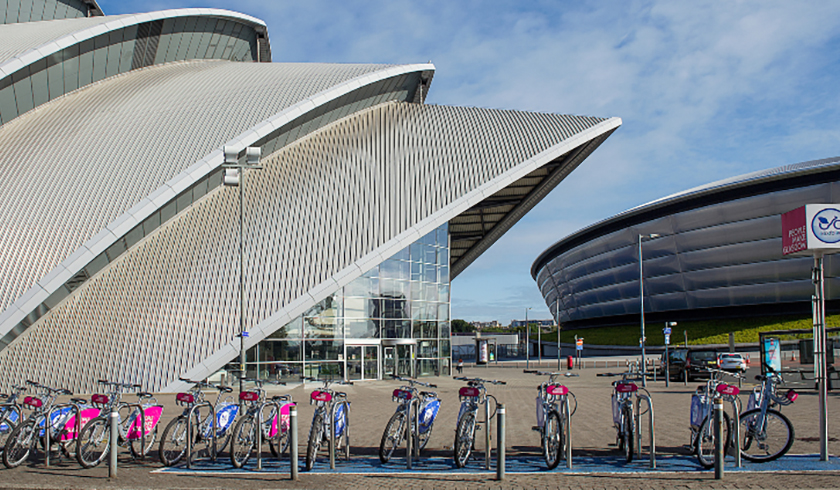 Bikes in a bike stand overlooking the SEC Armadillo and OVO Hydro.