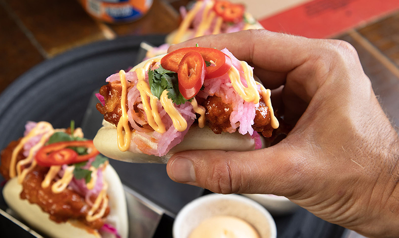 Hand holding taco in Clydebuilt restaurant.