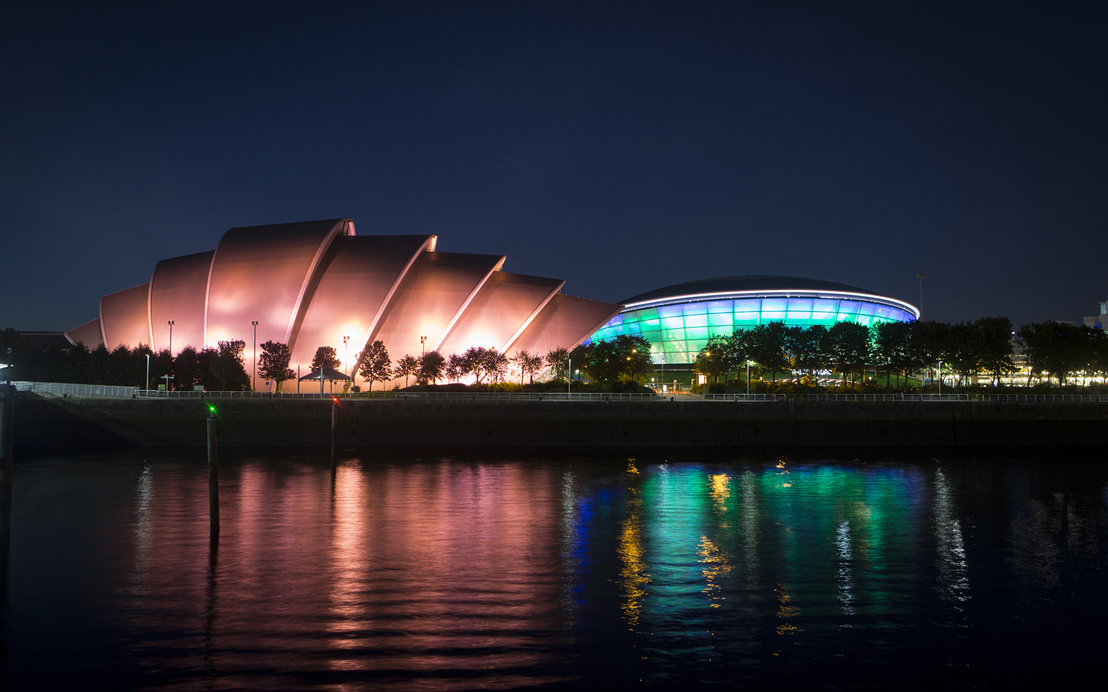 View of the SEC Armadillo and OVO Hydro from the River Clyde at night time.