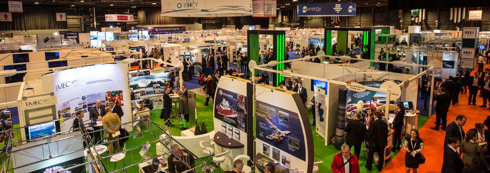 Image of an exhibition with exhibitors and attendees.